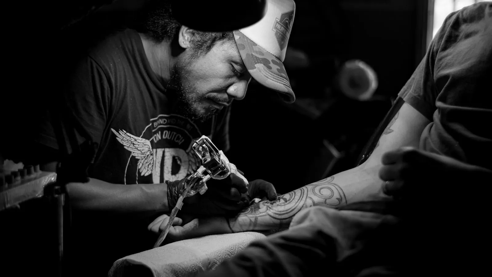 A tattoo artist at the machine