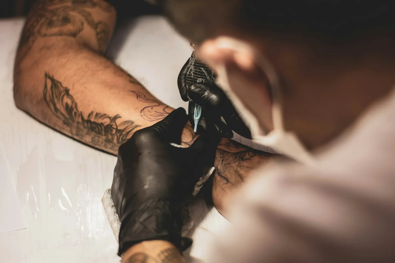 An artist laying down linework under studio light